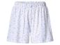 Witte damesshorts met blauwe bladeren en gele bessen, met elastische tailleband.