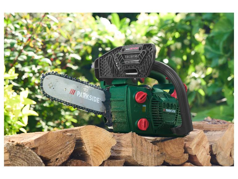 Parkside kettingzaag op een stapel gekapt hout in een tuin.