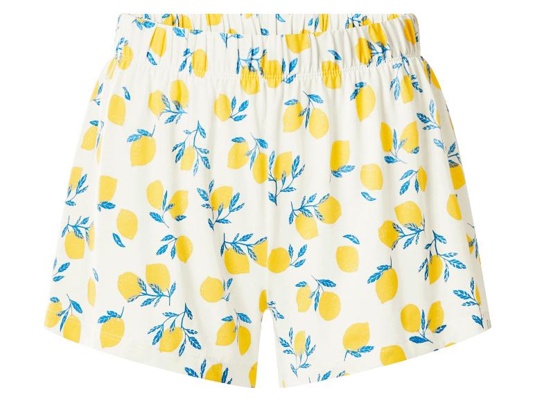 Witte short met een patroon van gele citroenen en blauwe bladeren.