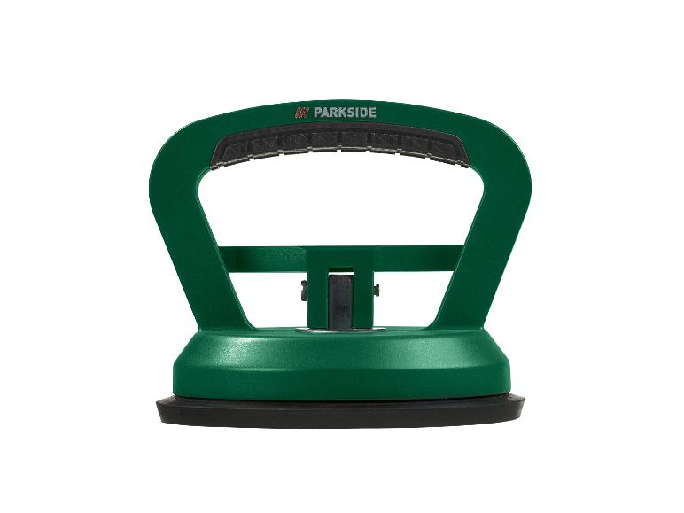 Groene glaszuignap met een zwart handvat en basis