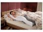 Vrouw slaapt comfortabel in bed met het LIVARNO home zijligkussen.