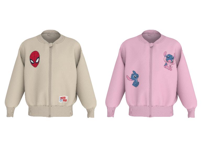 Twee kinderbomberjacks, één beige met een spinnenmasker, één roze met twee buitenaardse figuren.