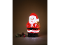 Verlichte kerstmanfiguur met feestelijke decoraties