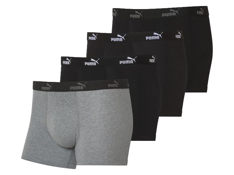 Drie Puma boxershorts: twee zwart, één grijs.