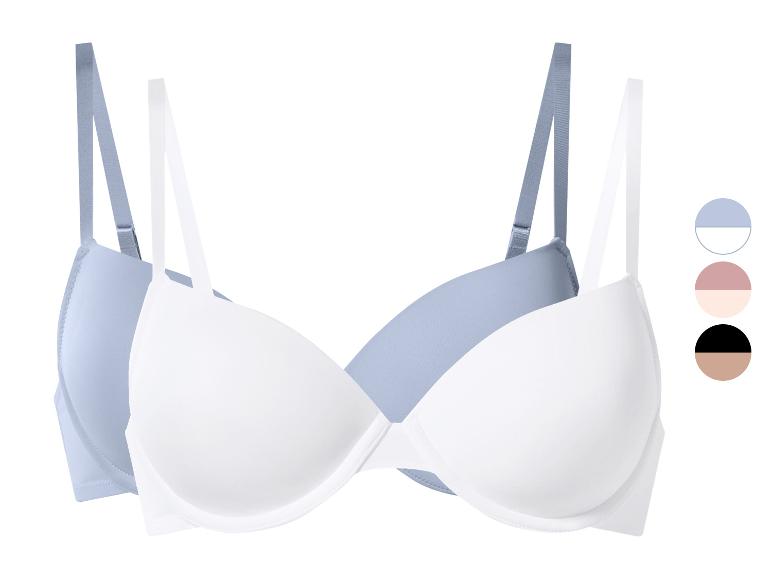 Set van twee beha's, één lichtblauw en één wit, met kleurstalen.
