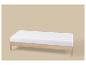 Licht houten bedframe met wit matras op een beige achtergrond