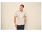 Man in beige T-shirt met 'SUMMER STATE'-opdruk en donkere jeans.