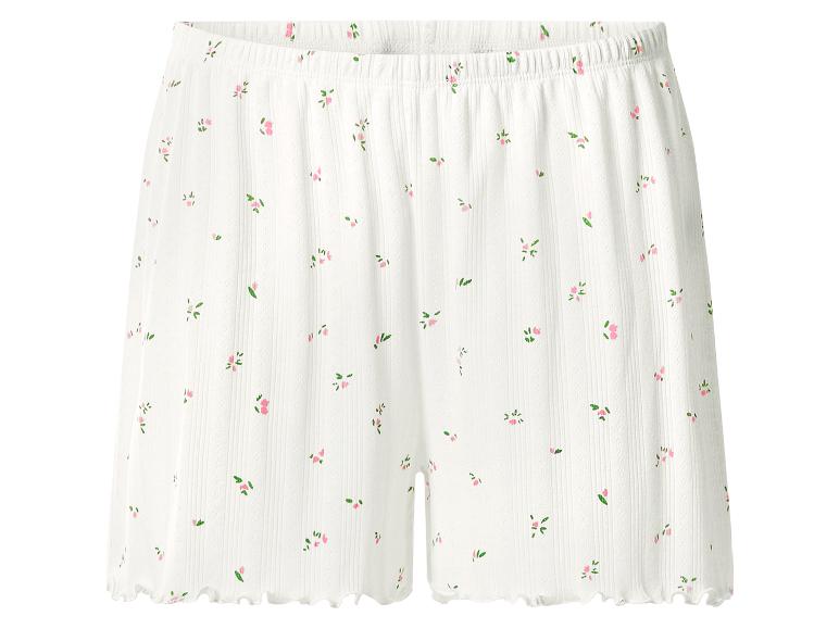 Witte geribbelde shorts met een delicaat roze bloemenpatroon en een rucheszoom.