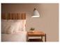 Slaapkamer met bed, houten hoofdbord, nachtkastje en hanglamp.
