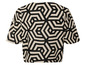 Beige top met zwart geometrisch patroon.