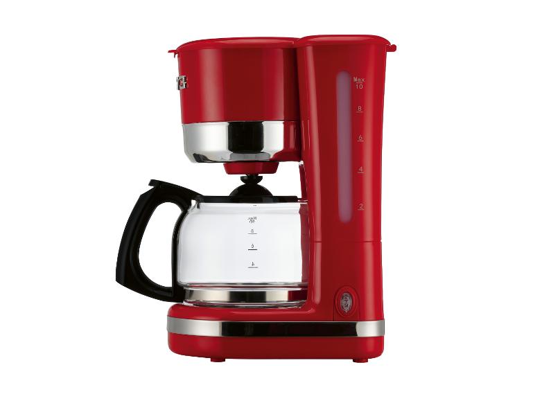 Rood koffiezetapparaat met glazen kan en zichtbare waterniveau-indicator.