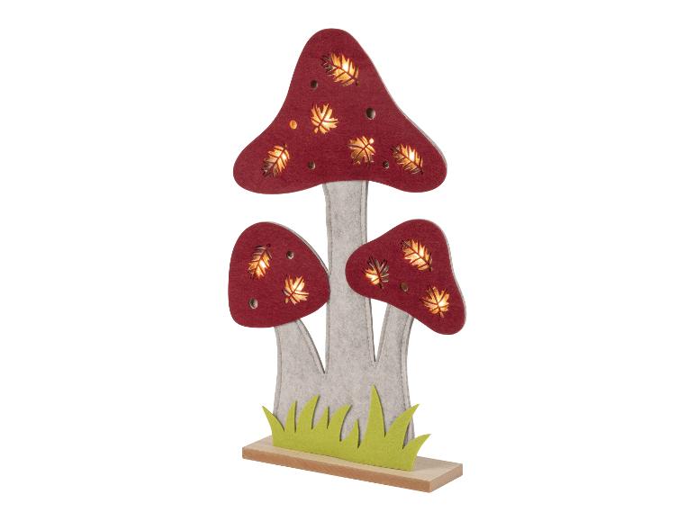 Vilt lampen in de vorm van paddenstoelen met uitgesneden bladeren.