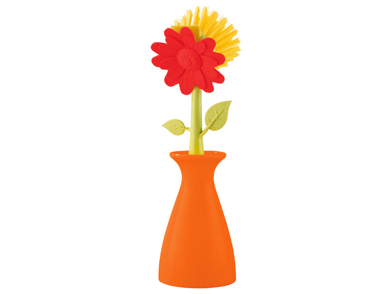 Een bloemachtig afwasborstel in een oranje vaas.