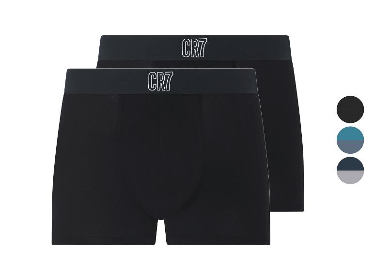 Twee zwarte boxershorts met donkere elastische tailleband en wit logo, met kleurstalen.