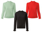 Drie gebreide truien in mintgroen, rood en zwart.