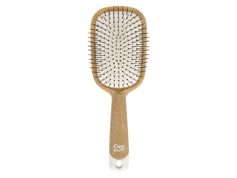 Cien Beauty haarborstel met beige handvat en zwarte pinnen op een witte achtergrond.