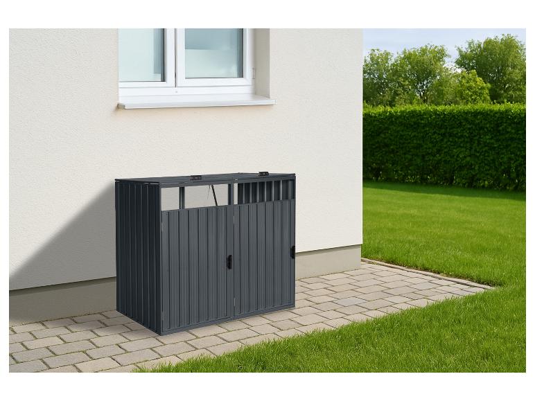Donkergrijze metalen afvalbakkenberging naast een huis met gazon