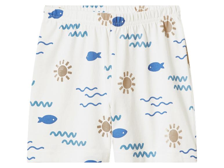 Witte kinder shorts met vissen, zonnen en golven patroon.