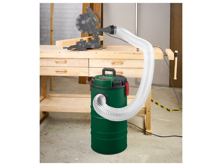 Een Parkside stofzuiger met een flexibele slang, aangesloten op een zaagmachine.