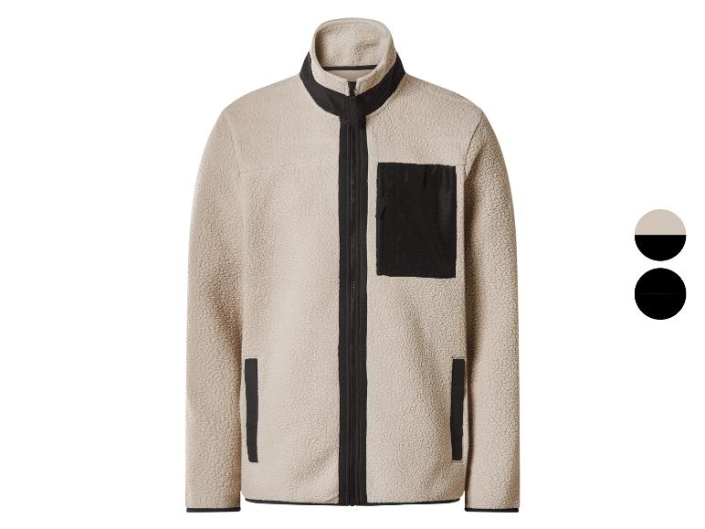 Beige fleecejack met zwarte rits en zakken