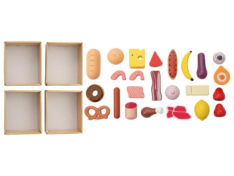 Lege dozen en een verscheidenheid aan speelgoedvoedsel, waaronder brood, fruit, vlees en snoep.