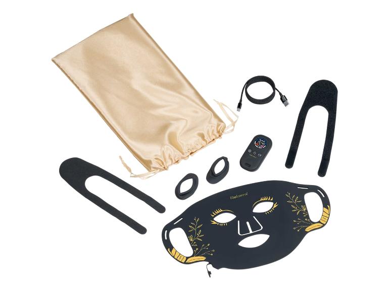 Zwart schoonheidsgezichtsmasker met gouden details, afstandsbediening en accessoires.