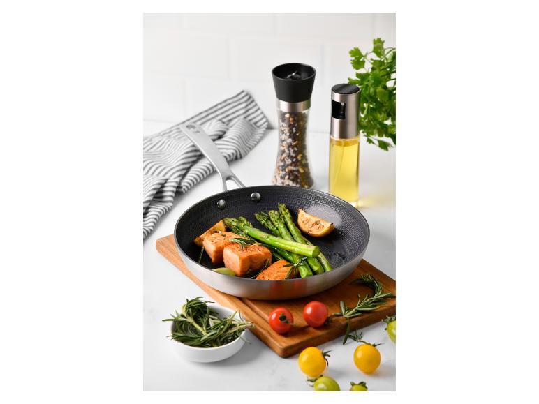 Zalm, asperges en koekenpan met accessoires.