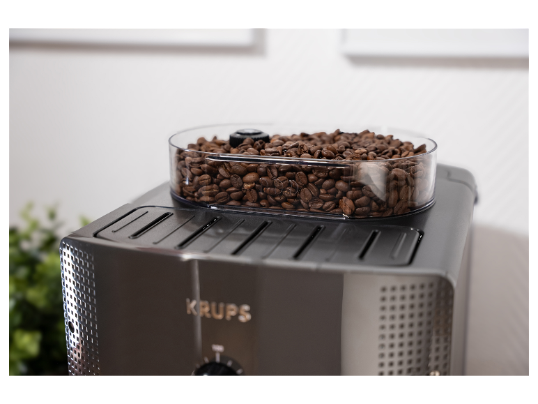 Een bak met koffiebonen op een Krups koffiezetapparaat.