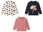 Drie longsleeve shirts met prints: een met appels, een met bloemen en een gestreept.