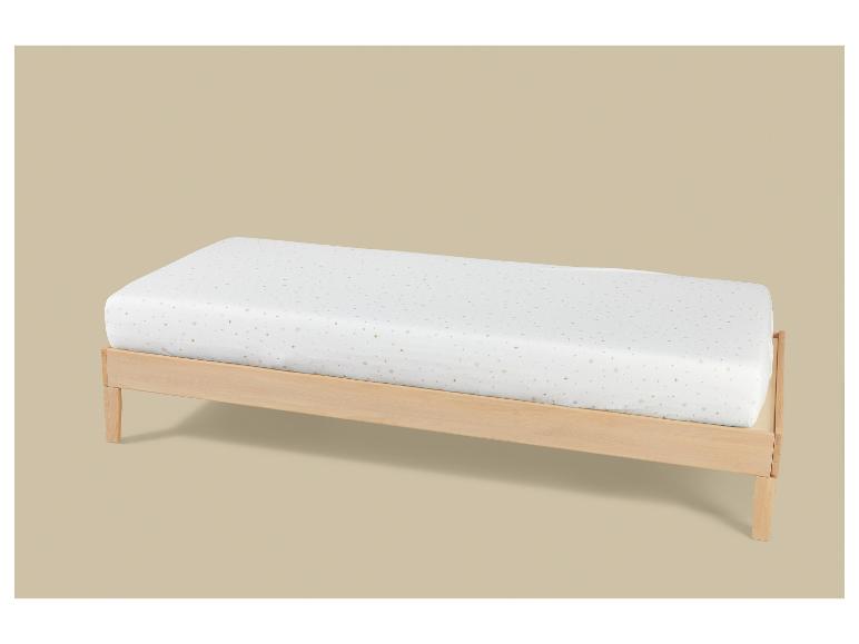 Houten bed met wit matras met gouden sterrenpatroon