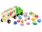Houten speelgoed vrachtwagen met vormsorteerder en Peppa Pig figuren.