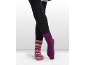 Persoon draagt zwarte leggings, één gestreepte sok en één effen paarse sok.