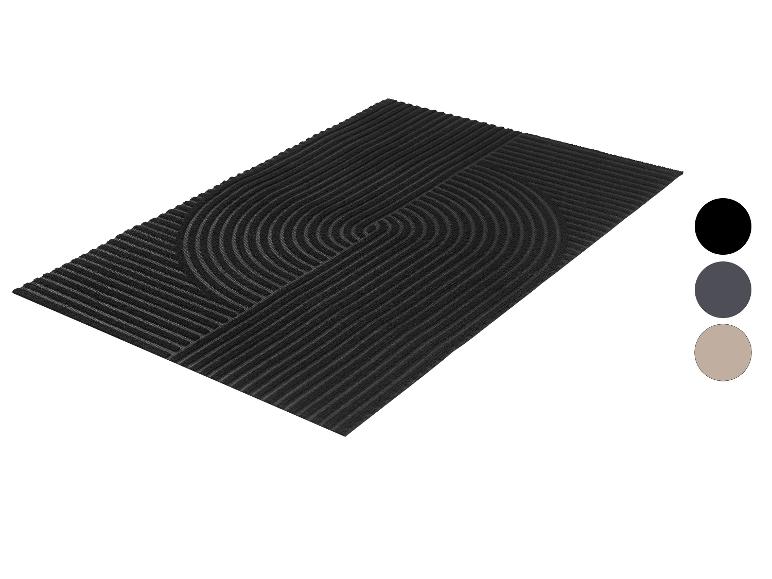 Zwarte rechthoekige deurmat met een geometrisch patroon van lijnen en halve cirkels.