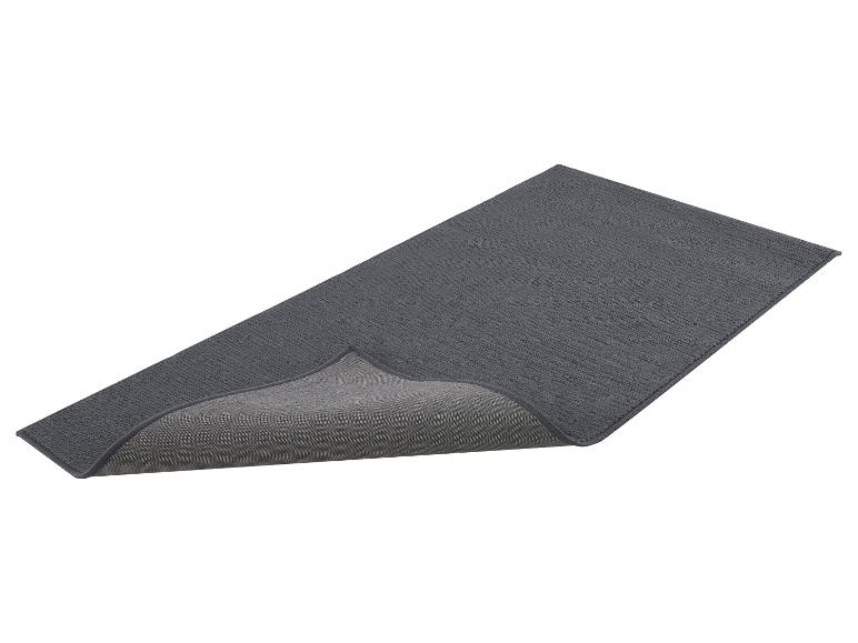 Donkergrijze badmat of loper met opstaande rand die de antislip onderkant toont.