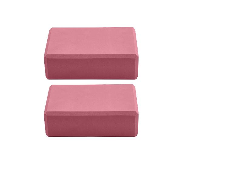 Twee roze yogablokken op een witte achtergrond
