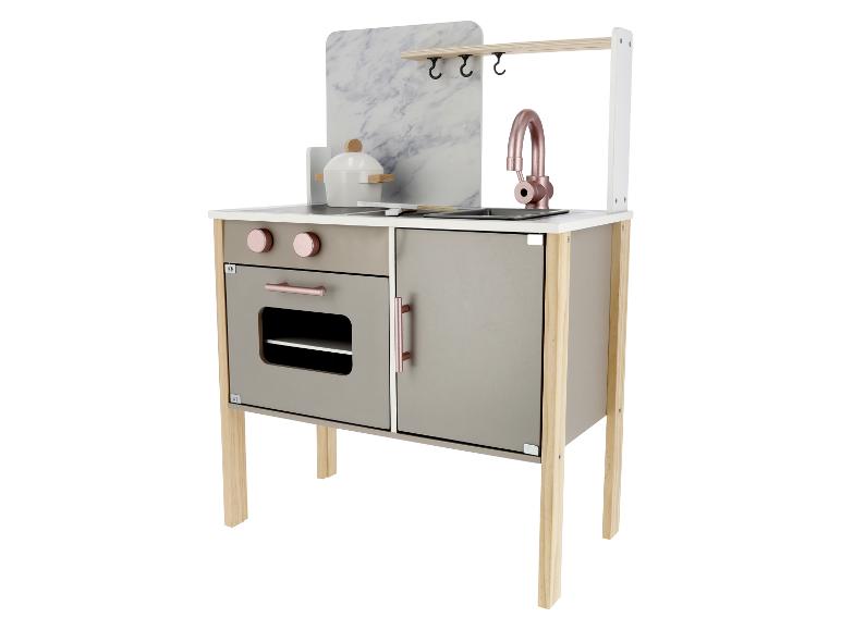 Een moderne speelkeuken met een marmeren achterwand, oven en gootsteen.