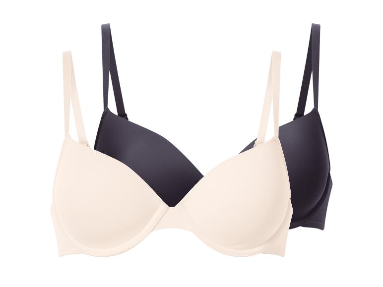 Twee beha's, één beige en één donkerblauw, overlappend op een witte achtergrond.