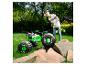 Een jongen bestuurt een Grave Digger RC monstertruck op gras, met rotsen op de voorgrond.