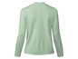 Groene gebreide trui met stippen.