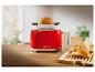 Rode 1995 toaster met brood erop.