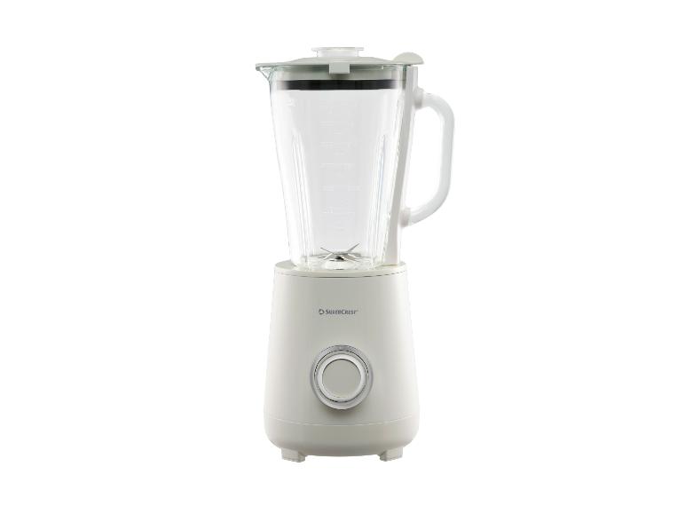Witte blender met glazen kan en zilveren knop aan de voorkant.