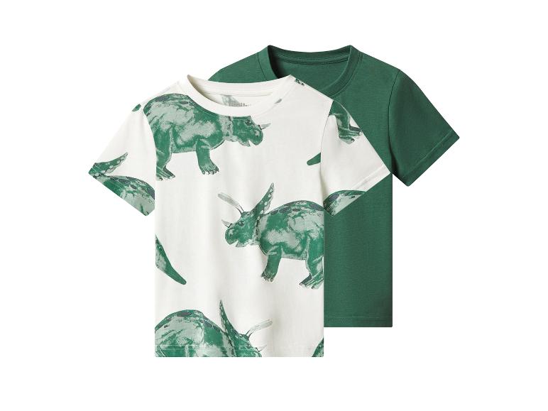 Twee kinder T-shirts: één wit met groene dinosaurussen, de andere effen groen.