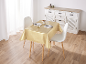 Eettafel met gouden tafelkleed, twee stoelen en een wit dressoir.