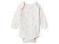 Witte baby romper met lange mouwen en roze madeliefjespatroon