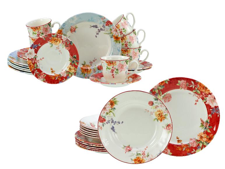 Bloemig servies met borden en kopjes in rood, blauw en wit.