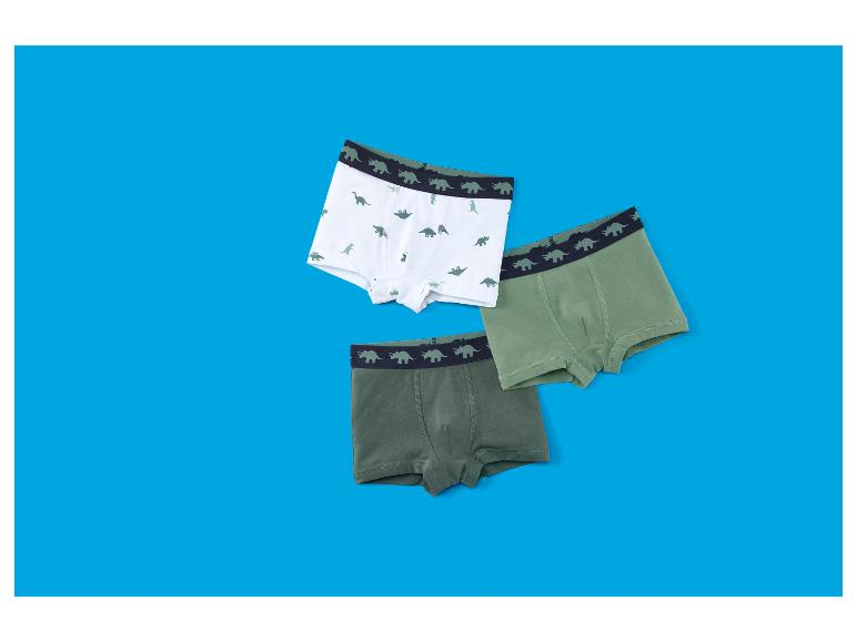 Drie jongensboxershorts met dinosauruspatroon in wit en groen.