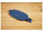 Blauw plastic deksel voor een waterfilterkan op een houten ondergrond.