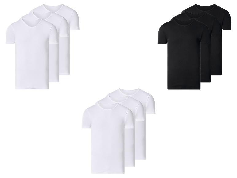 Verpakkingen witte V-hals en ronde hals T-shirts, en zwarte ronde hals T-shirts.