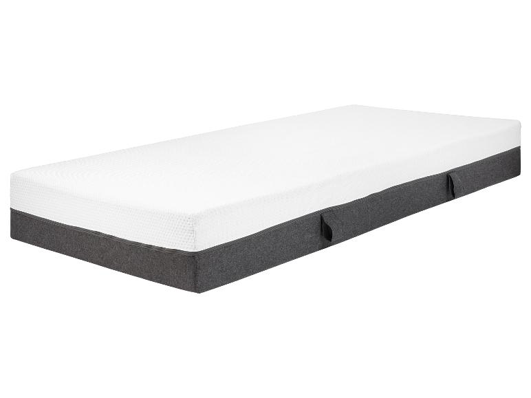 Een wit matras met een grijze hoes en handvatten.