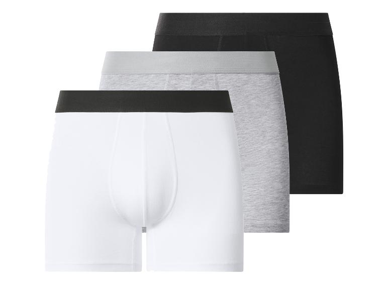 Drie herenboxershorts: wit, grijs en zwart.
